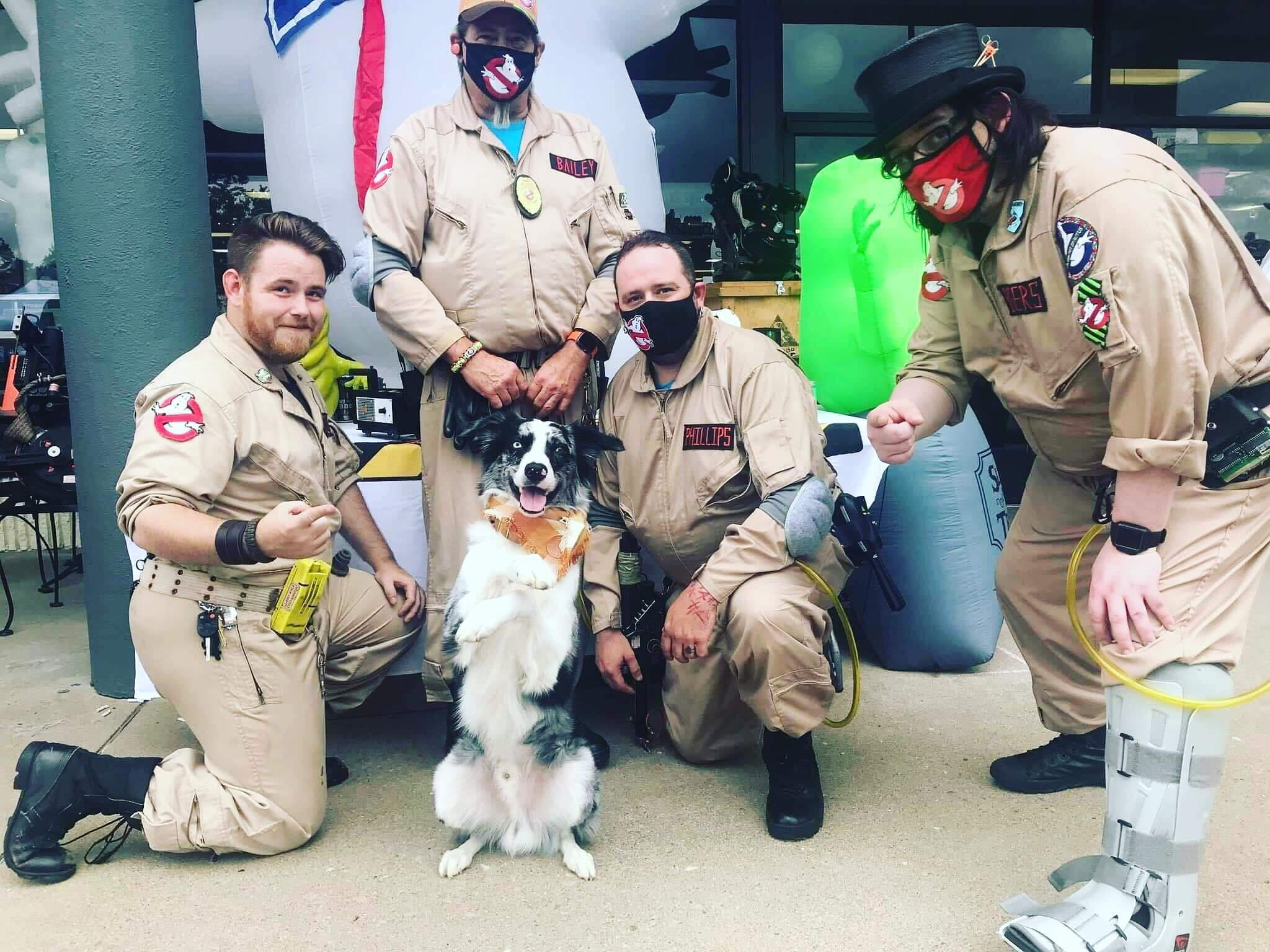 Ghostbusters Virginia member posing with a Proton Pets pup